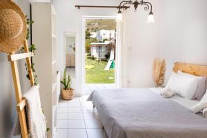 a bedroom with a bed and a door to a yard at Villa peristeri in Alinda