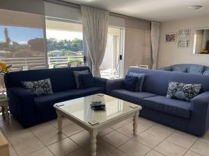 a living room with blue couches and a coffee table at 22 Lands End in Ballito