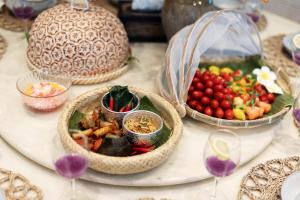 a table topped with bowls of fruit and vegetables at 25,000sq.ft Grand Luxe Villa PJ 13BR 42Pax By Verano in Petaling Jaya
