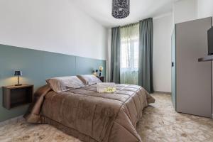 a bedroom with a large bed and a window at Casa della Civetta in Monopoli
