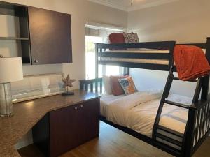 a bedroom with a bunk bed and a desk with a bunk bed at Quite Spacious, Hot Tub Near Montecito, EV Charger in Santa Barbara