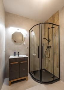 a bathroom with a shower and a sink at Apartament 33 in Gąski