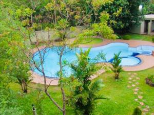 an overhead view of a swimming pool in a garden at Hotel Lihini Village Dambulla in Dambulla