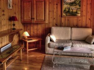 a living room with a couch and a table at 4 6 pers holiday appartment near center of Champagny in Le Villard