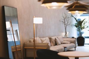 a living room with a couch and a lamp at Hotel Zenit Bilbao in Bilbao
