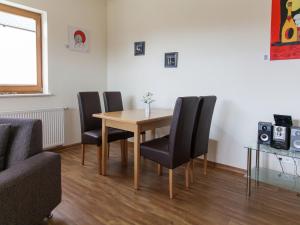 a dining room with a table and four chairs at Lovely Apartment in M rz with Garden Balcony in Lahr