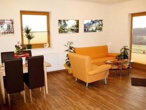 a living room with a couch and a table at Lovely Apartment in M rz with Garden Balcony in Lahr