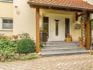 a front door of a house with a porch at Cozy Apartment in Marktrodach with Sauna in Kronach