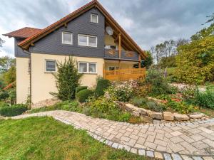 a house with a garden in front of it at Cozy Apartment in Marktrodach with Sauna in Kronach