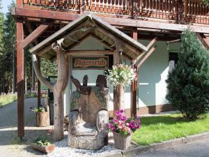 a statue of a rabbit in front of a house at Luxurious Apartment in J gersgr n with Saunas in Jägersgrün