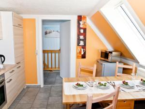 a kitchen and dining room with a table and chairs at Idyllic Apartment in Bastorf with Balcony in Kägsdorf