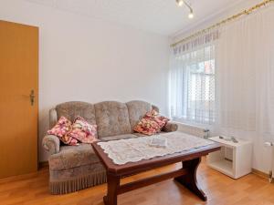 a living room with a couch and a coffee table at Attractive Apartment in Kl tz near the Sea in Klütz