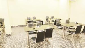 a classroom with desks and chairs in a room at Hotel R R . Puri fully-air-conditioned-hotel near-sea-beach-&-temple with-lift-And restaurant-availability in Puri