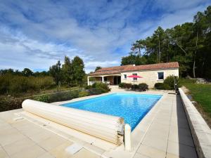 an image of a swimming pool in front of a house at Holiday home in Montcl ra with sunny garden playground equipment and private pool in Montcléra