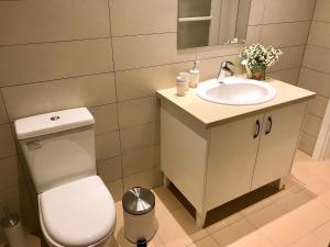 a bathroom with a toilet and a sink at Avgi's Home in Limassol