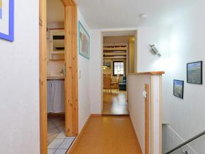 a hallway leading to a kitchen and a living room at Cozy Apartment in L wensen Lower Saxony with Private Terrace in Bad Pyrmont