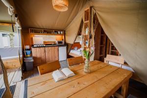 a dining room with a table in a tent at Glamping Tents in Tuhelj with thermal riviera tickets in Tuheljske Toplice