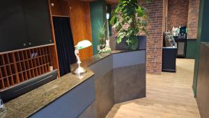 a bar with potted plants on the counter at theAmbassador Hotel I Essen City in Essen