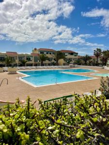 a large swimming pool in front of a resort at Casa Las Torres 209 in Costa de Antigua