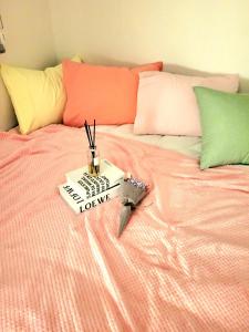 a bed with a book on top of it with a knife at 하이스테이원당53 in Koyang