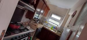 a small kitchen with a stove and a window at Lovely 5Bedroom Villa -Compound - Swimming Pool at Green Oasis Resort in ‘Izbat as Sarāḩnah
