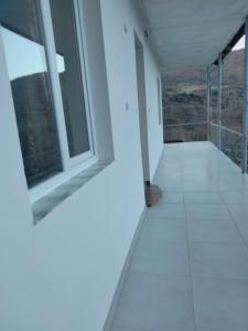 an empty room with a window and a white floor at MD Guest House in Getahovit