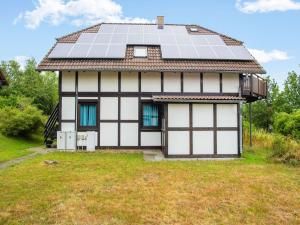 a house with solar panels on the roof at Spacious Apartment in Frankenau Hesse near the Forest in Frankenau