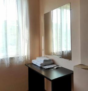 a bathroom with a mirror and a table with towels at MD Guest House in Getahovit