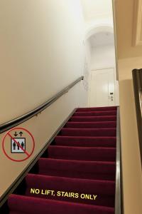 a staircase with a no lift stairs only sign on it at Amsterdam Rembrandt Square city center Hotel in Amsterdam