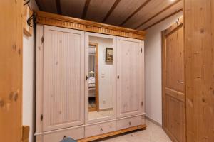 a room with wood paneling and a large cabinet at Jagahäusel Appartement Gitti in Jochberg