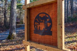 a wooden sign for a union fireagency in a forest at Hidden Hideaway cabin in Cosby