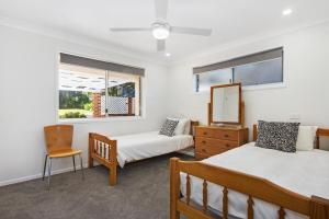 Un dormitorio con dos camas y un espejo. en Bellevue, en Manyana