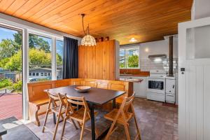 a dining room with a table and chairs in a kitchen at Town Gem in Taupo