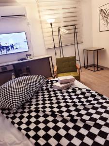 a living room with a bed with a checkered floor at 하이스테이원당53 in Koyang