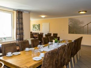 a conference room with a long table and chairs at Large apartment in the beautiful Sauerland with garden patio and sauna in Erndtebrück