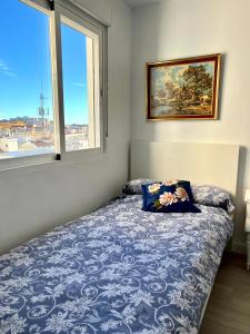 a bedroom with a bed with a pillow and a window at Rare find! Skyline view-Modern 6 bed 2 bath flat in the heart of Málaga in Málaga