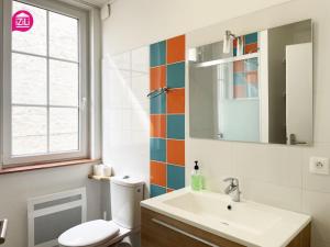 a bathroom with a toilet and a sink and a window at Le Paul by iZiLi - Centre Ville - Gare in Niort