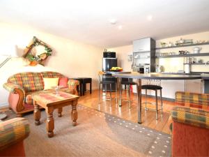 a living room with a kitchen and a table at Comfortable holiday home in the Weser Uplands with saunas and solarium in Schieder-Schwalenberg