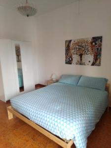 a bedroom with a bed with a blue comforter at casa vacanza Sulmona centro in Sulmona