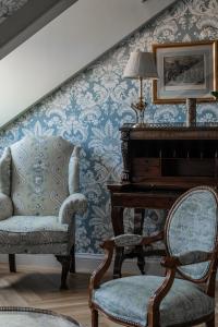 a living room with a chair and a piano at Relais & Châteaux Hotel Orfila in Madrid