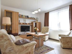 a living room with two chairs and a television at Cosy Apartment in Pepelow near Baltic Sea in Pepelow