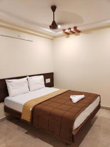 a bedroom with a large bed in a room at HOTEL DKR GRAND in Tirupati