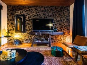 a living room with a flat screen tv on a wall at Large detached holiday home in Willingen with garden in Willingen