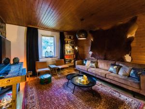 a living room with a couch and a wall at Large detached holiday home in Willingen with garden in Willingen