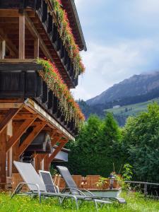 a group of chairs sitting on the side of a building at Alpenhotel Sonneck - mit Bergbahnticket in Bad Hindelang +72 photos