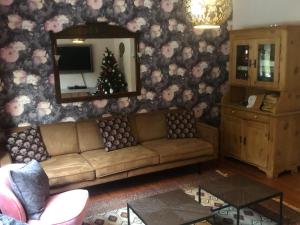 a living room with a couch and a christmas tree at Large detached holiday home in Willingen with garden in Willingen