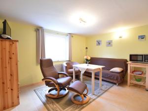 a living room with a couch and a table at Modern Apartment in Elmenhorst near Sea in Elmenhorst