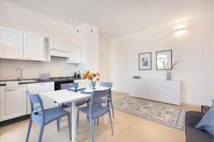 a kitchen and dining room with a table and chairs at Sve Suites Cagliari in Cagliari +17 photos