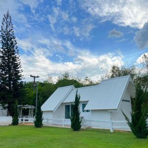 a white barn with a white roof and two trees at Quality Time Farmstay: YardHouse#5 in Ban Pa Lau +13 photos