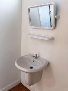 a bathroom with a sink and a mirror on the wall at Quality Time Farmstay: YardHouse#5 in Ban Pa Lau